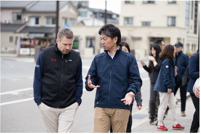 Two men walking through urban area during city visit