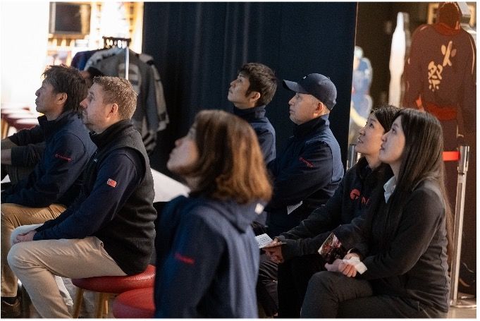 Group of people at indoor event space during presentation or gathering