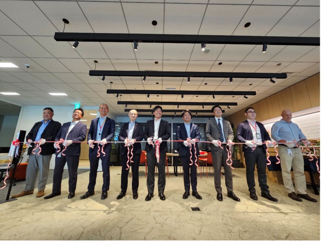 Ribbon cutting ceremony with multiple businessmen at office opening