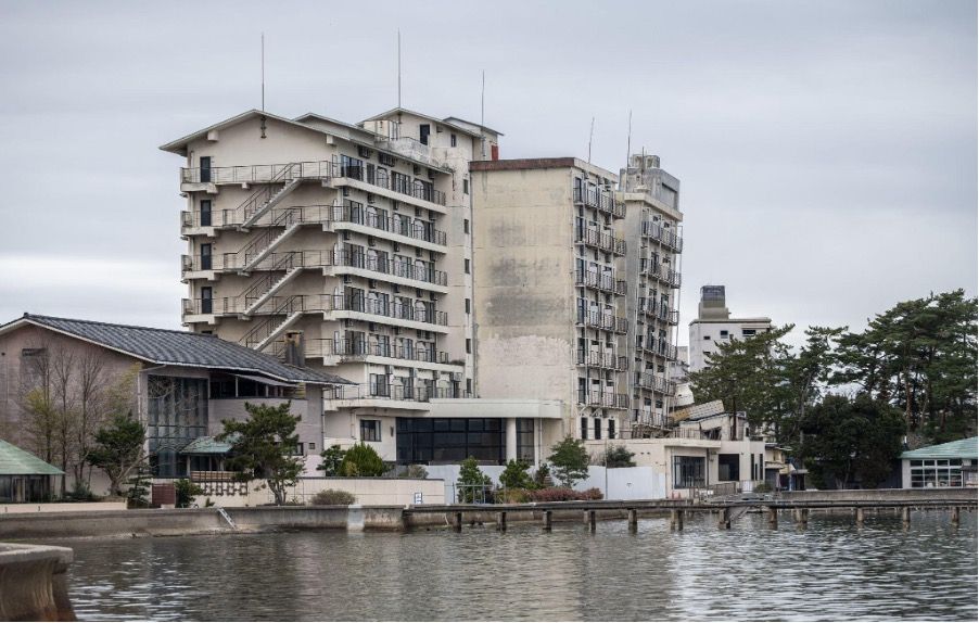 Waterfront buildings and landscape with river in foreground