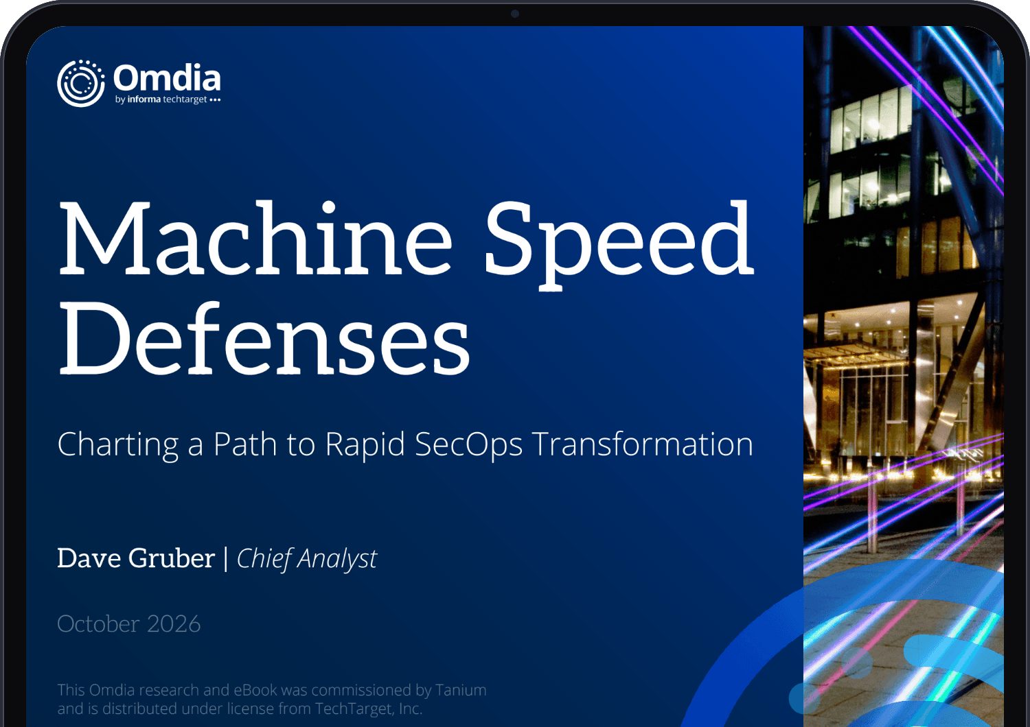 Omdiaの電子書籍『Machine Speed Defenses: Charting a Path to Rapid SecOps Transformation』(著者:チーフアナリスト、デイブ・グルーバー氏)の表紙が、タブレットに表示されています。